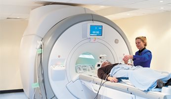 Professor Dorothee Auer and MRI scanner